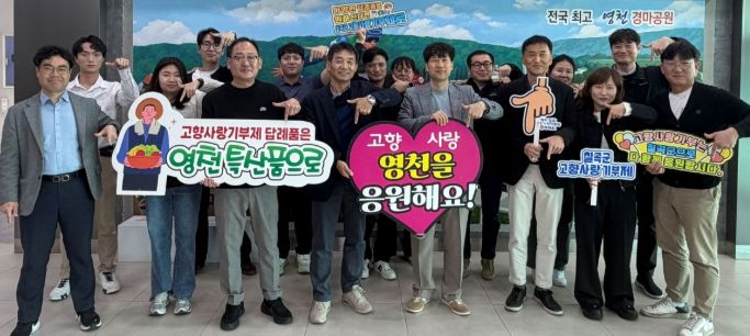 영천시와 칠곡군 도시계획과 직원들이 상호 100만원씩 고향사랑기부금을 전달하고, 기념촬영을 하고 있다.
